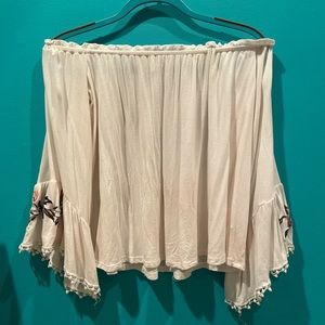 flowy cream colored off-shoulder blouse